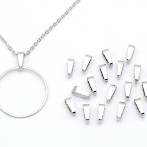 May include: A silver chain necklace with a circular pendant and a set of 20 silver jump rings.