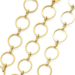 May include: A gold chain necklace with a series of connected circular links.