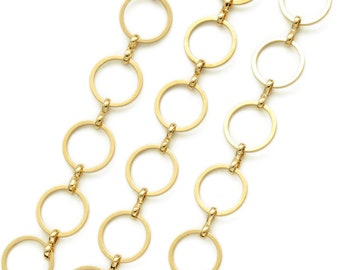 May include: A gold chain necklace with a series of connected circular links.