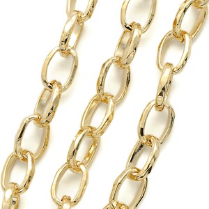 May include: Three strands of gold chain with oval links. The chain is textured and has a shiny finish.