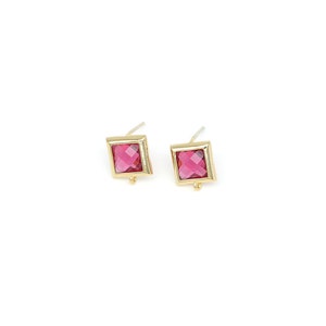 May include: A pair of gold earrings with square-shaped pink gemstones.