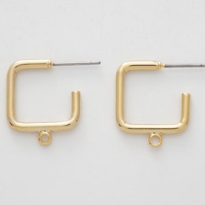 May include: A pair of gold square hoop earrings with a small jump ring at the bottom of each hoop.