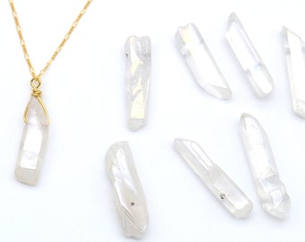 May include: A set of ten iridescent white crystal points with a gold chain and pendant. The crystal points are all different sizes and shapes, and they have a beautiful iridescent sheen.