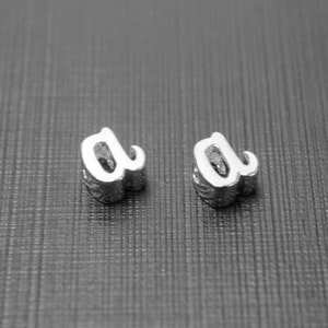 2 pieces, MARKDOWN, Alphabet a, Nickel free, AA-R5, 5x5x3mm, Hole size 1.6x1.6mm, Cursive letter, Rhodium plated brass