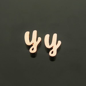 May include: Two gold-colored cursive letter 'y' charms.