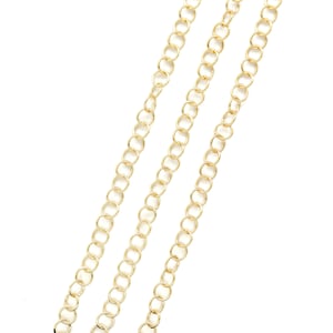 May include: Three gold chains with a delicate, round link design. The chains are arranged in a diagonal pattern against a white background.