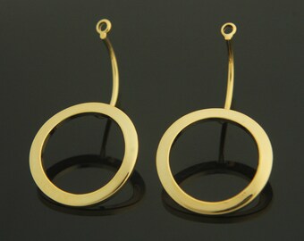 May include: A pair of gold-toned hoop earrings with a simple, circular design. The earrings have a wire loop at the top for attaching to an earring post.