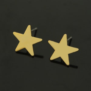 May include: A pair of gold star-shaped stud earrings.