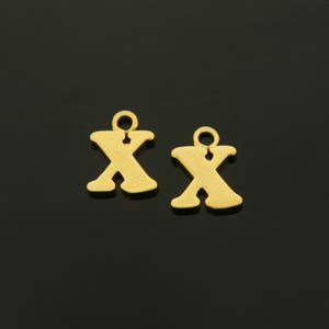 May include: Two gold-colored metal letter X charms with a loop at the top for attaching to jewelry or other crafts.