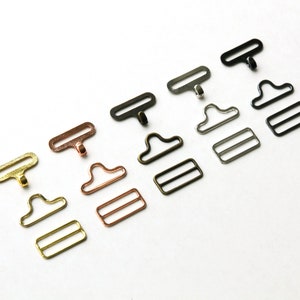 May include: Five sets of metal clasps in different finishes: gold, copper, silver, black, and gunmetal. Each set includes a hook, a D-ring, and a slider.