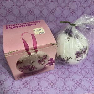 May include: A white ceramic pomander ornament with a floral design. The ornament is packaged in a pink box with the text "Hammersley Pomander" and a price tag that reads "£7.95".