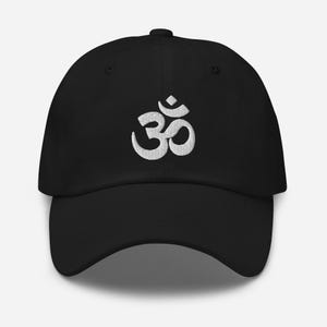 May include: A black baseball cap with a white embroidered Om symbol.
