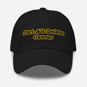 May include: Black baseball cap with a yellow embroidered design that says "Ctrl-Alt-Delete Cancer".