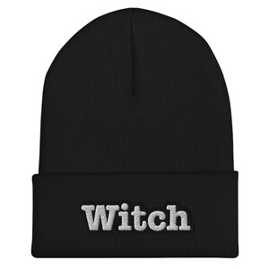May include: Black beanie with a white embroidered word "Witch" on the front.