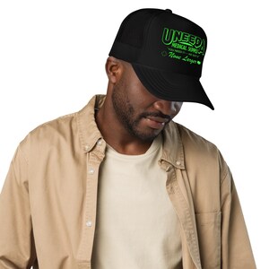 May include: A black trucker hat with a green logo that says "Uneeda Medical Supply - You Need It - We Got It - None Larger".