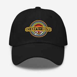 May include: Black baseball cap with a rainbow and yellow embroidered logo that says "con-am 27"