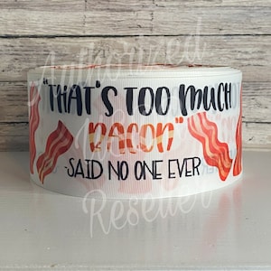 May include: White ribbon with a black and orange print of bacon and the text "That's too much bacon" - said no one ever.