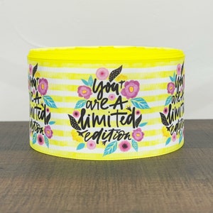 May include: Yellow and white striped ribbon with a floral design and the text "You are a limited edition".
