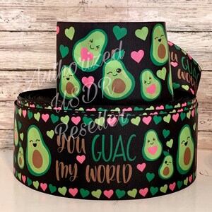 May include: Black and green ribbon with a repeating pattern of avocados and hearts. The avocados have smiling faces and the text "You Guac My World" is printed in brown.