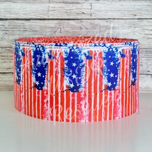 May include: Red, white, and blue ribbon with a distressed American flag design. The ribbon is rolled up and ready to be used for crafts or decorations.
