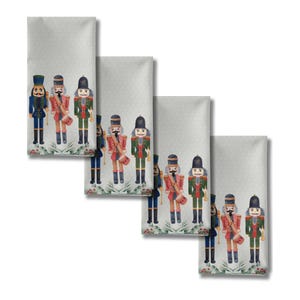 May include: Four gray decorative cloth napkins with a repeating pattern of watercolor nutcracker soldiers in various uniforms. The napkins have a subtle dotted background and a floral border at the bottom.