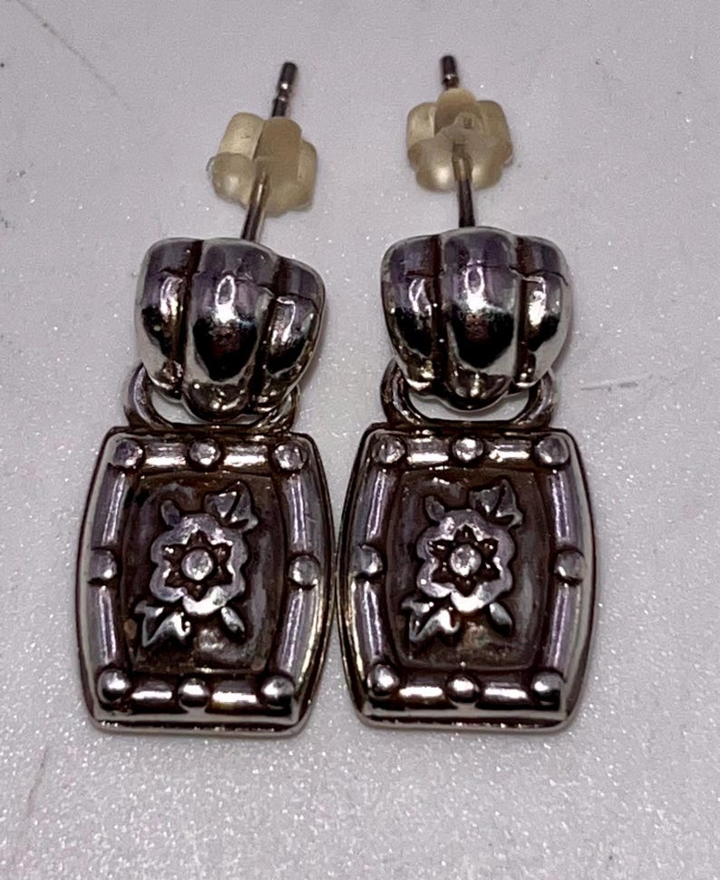 May include: A weathered wooden sign, inscribed with 'Welcome to our home' in white. The sign has a distressed appearance, ideal for a porch or hallway, creating a warm and inviting atmosphere.