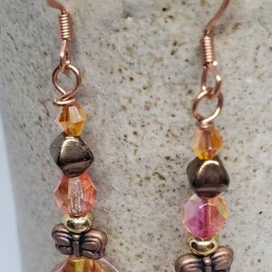 BOHO Peachy Orange Swarovski Copper and Czech glass with Pressed Flower and Copper Butterfly accent and wires.