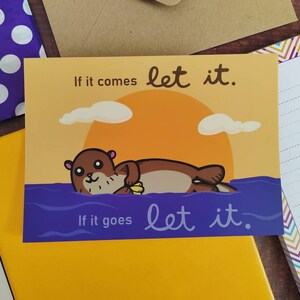 Süßer Otter ""Let it"" bunte positive Affirmationspostkarte." Perfekt als Erinnerung oder Geschenk. Toll für Briefpapier oder Postkartentausch