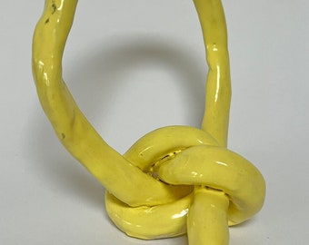 Ceramic yellow knot sculpture