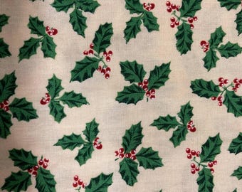 May include: A fabric with a repeating pattern of green holly leaves and red berries on a cream background. The design is a festive, seasonal print, suitable for holiday-themed crafts and decor.