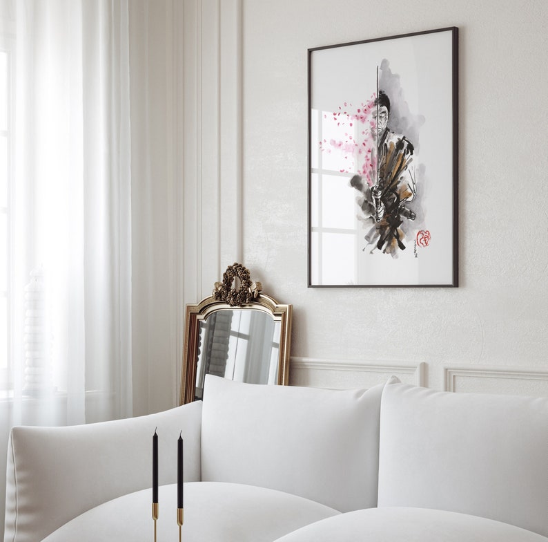 May include: Framed art print featuring a watercolor illustration of a samurai warrior with a sword, accented by pink cherry blossoms. The artwork is in a black frame and hangs on a white wall. The overall aesthetic is minimalist and elegant.