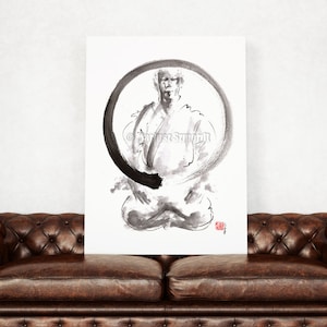 May include: A black and white ink painting of a person in a seated meditation pose, framed by a large black circle. The artwork is on a white canvas, with a red stamp in the lower right corner. The canvas is displayed above a brown leather couch.