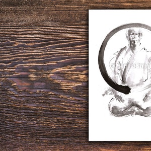 May include: Black and white ink drawing of a person in a seated meditation pose, framed by a large, incomplete circle. The artwork is on white paper, with a red stamp in the lower right corner. The background is a wooden surface.