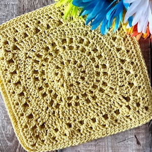 May include: A yellow crocheted square with a textured pattern. The square is made with a single crochet stitch and has a granny square design.