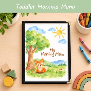 May include: A framed print titled My Morning Menu featuring a watercolor illustration of a fox sitting in a grassy field with a tree, blue sky, and yellow sun. The frame is black with gold corner accents, displayed on a light wood surface.
