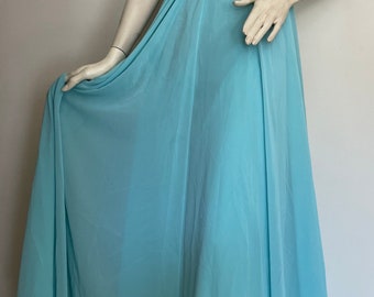 May include: A light blue, floor-length gown with spaghetti straps and a beaded empire waist. The dress is made of a flowing, sheer fabric, and is displayed on a mannequin.