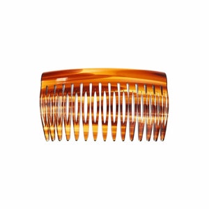 Könnte beinhalten: Ein brauner Schildpatt-Haarkamm mit einer gebogenen Form und einer Reihe von Zähnen.