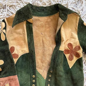 Vintage 1960's suede/leather bomber style jacket with appliquéd flower pattern.
