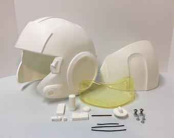 May include: A white plastic helmet with a clear visor, a back piece, and various small parts, including screws, a small cylinder, and a metal rod.