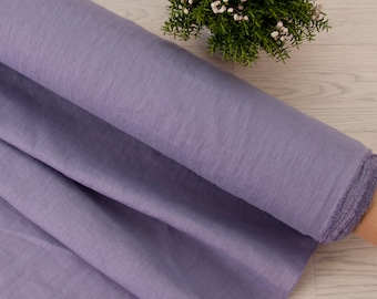 May include: A roll of soft, light purple fabric with a slightly textured surface. The fabric is folded and rolled up, and the edges are visible.