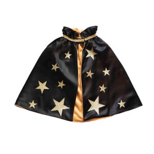 A black cape with gold stars on it against a white background.