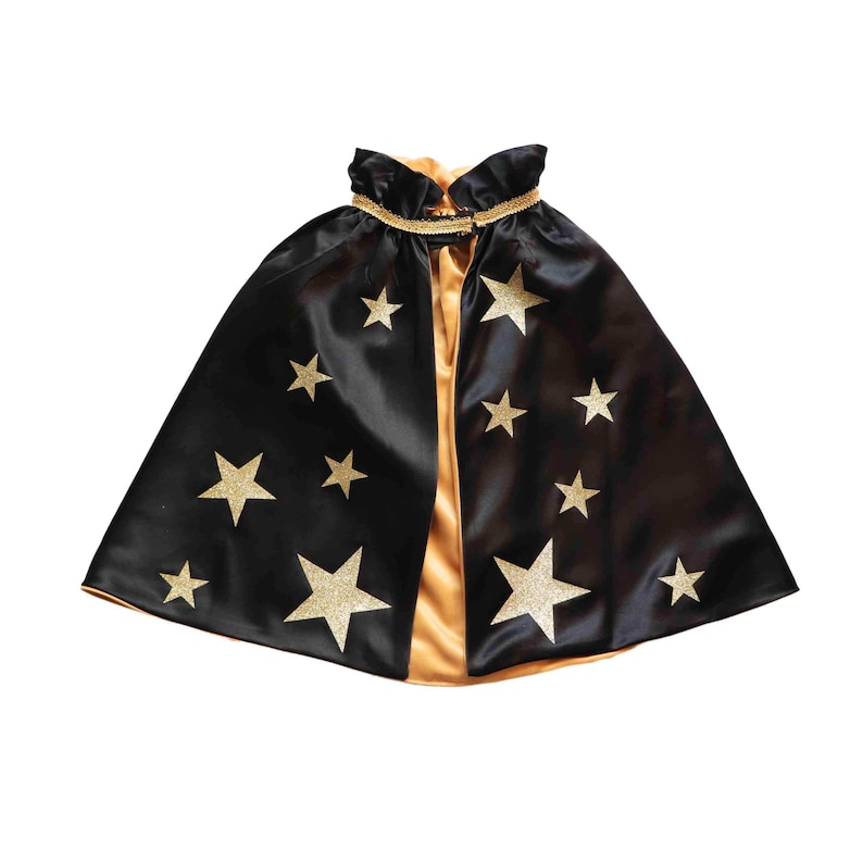 A black cape with gold stars on it against a white background.
