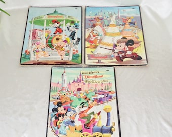 May include: Three vintage Walt Disney's Disneyland jigsaw puzzles. The puzzles feature scenes from Main Street, Frontierland, and Fantasyland. Each puzzle has a colorful illustration of Mickey Mouse and other Disney characters.