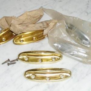 May include: Four gold-coloured metal door handles with three holes each. The handles are packaged in a clear plastic bag with a white paper label that says "C630-21".