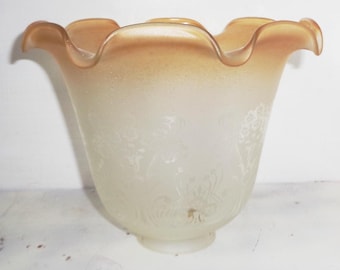 May include: A frosted glass lampshade with a scalloped edge and a floral design. The shade is a light brown color with a white frosted finish.