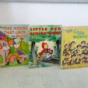 May include: Three vintage children's books with colorful covers. The first book is titled "The House That Jack Built" and features a boy in a green outfit holding a hammer. The second book is titled "Little Red Riding Hood" and features a girl in a red hooded cloak. The third book is titled "Ten Little Monkeys" and features a group of monkeys.