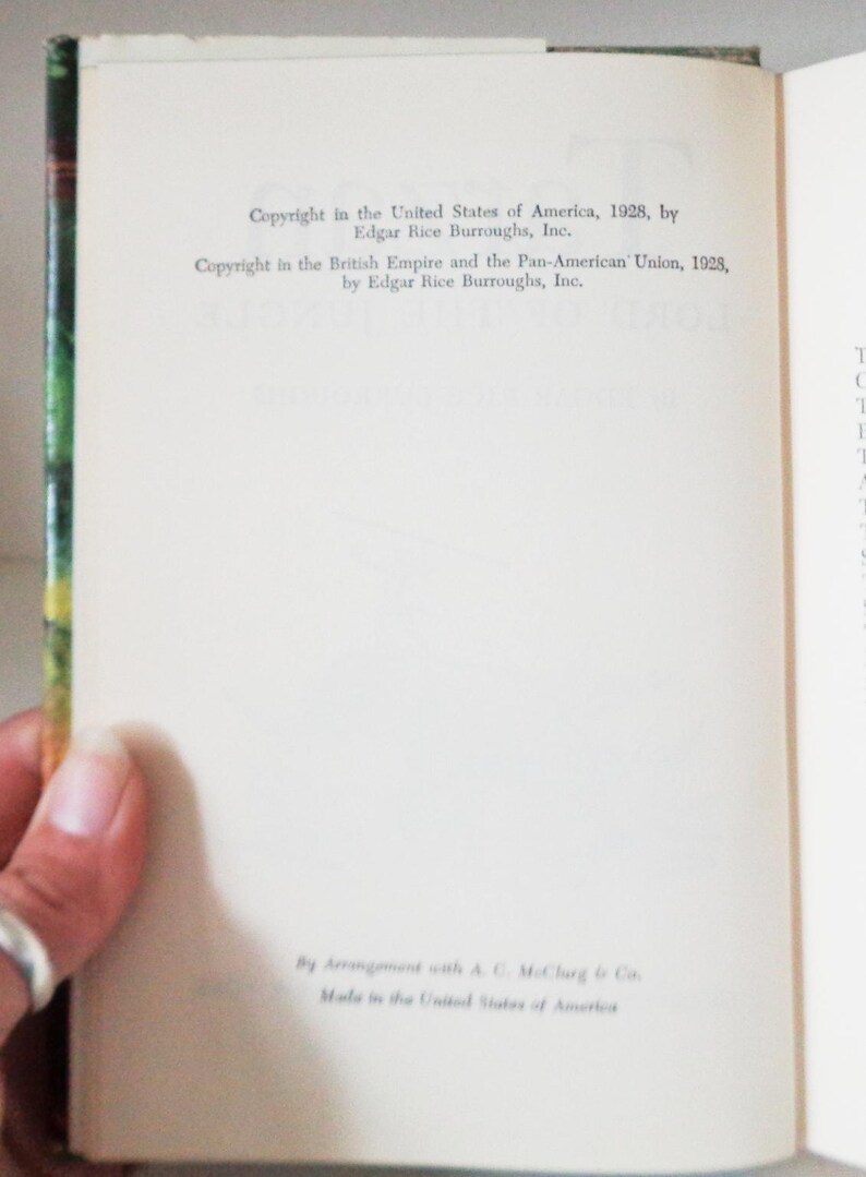 May include: A close-up of a book's copyright page, showing the copyright information for the book "Tarzan and the Jewels of Opar" by Edgar Rice Burroughs, Inc. The copyright dates are 1928 for the United States of America and the British Empire and the Pan-American Union.