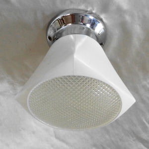 May include: A white ceiling light fixture with a chrome base and a diamond-shaped pattern on the glass shade.