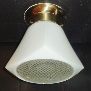 May include: A white ceiling light fixture with a brass base and a diamond-patterned glass shade.