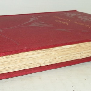 May include: A vintage, red hardcover book with gold lettering and floral designs. The book's pages are aged, and the cover shows signs of wear. The author's name, S.K. Brown, is visible on the spine. The book is lying on a white surface.